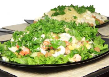 Salad with shrimps, dried crust, green peas and leaf of lettuce. Isolated