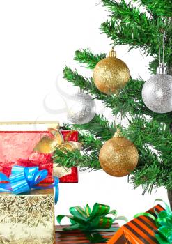 Fragment of Christmas and New Year Tree with gift boxes. Isolated over white background.