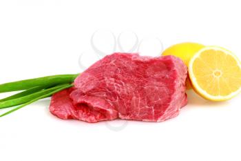 Cut of  beef steak with lemon slice and onion. Isolated.