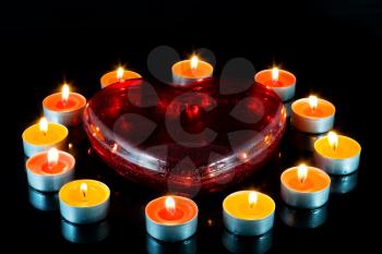 Heart, surrounded small candles light .