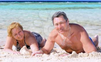 Mature couple on the beach in the tropical resort.