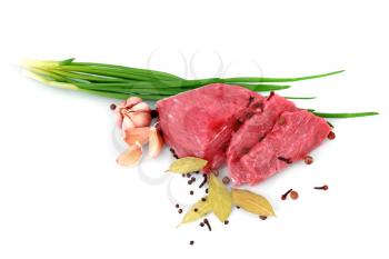 Cut of  beef steak  with garlic  slice, onion and laurel. Isolated.