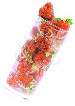 Glass with fresh strawberries and soda on white background. Isolated