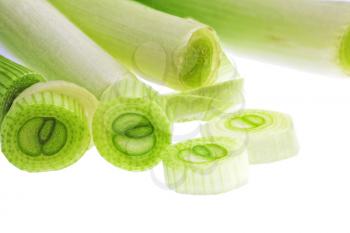 Cutting young onion on white background. Close-Up. Isolated