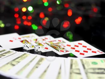 Dice and playing cards- poker royal flesh. On back background -casino lights.