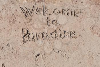 Inscription Welcome to Paradise on   beach.