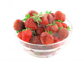 A heap of fresh strawberries in glass bowl  . Isolated