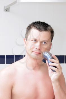 Young men shaving in bathroom