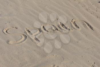 Inscription Welcome to Spain on a sand n a  beach.