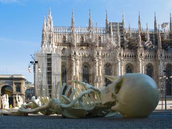 Cathedral Duomo  in Milan  at   left wing of Cathedral.  In front view a skeleton. Italy