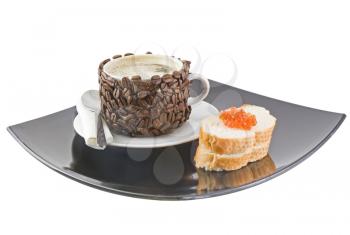 Cup of coffee with cream, red caviar on bread. Isolated over white