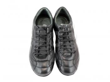Leather black sneakers on white. Isolated over white.