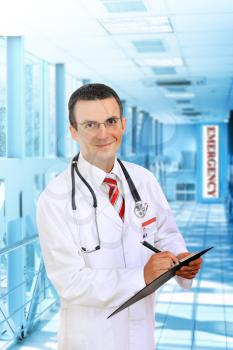 Friendly medical doctor stand in Hospital corridor.