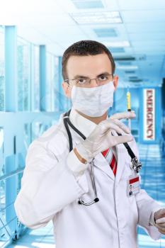 Doctor stand and hold a medical syringe with medication  in Hospital.