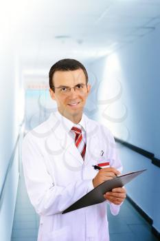 Friendly medical doctor stand in Hospital corridor.