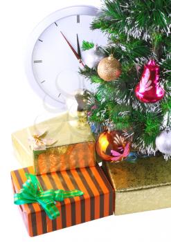 New Year and Christmas Tree and gift boxes, clock . Isolated over white background.
