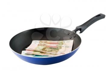 Frying pan with the russians moneys- roubles. Fried money.Top view. Isolated