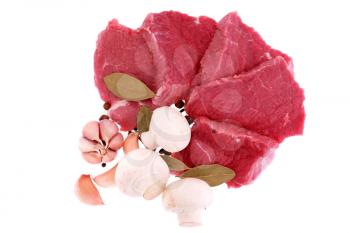 Cut of  beef steak  with  laurel, onion, garlic and  flavouring. Isolated.