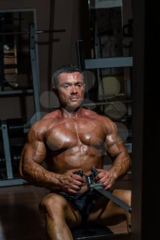 male body builder doing heavy weight exercise for back