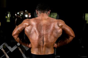 muscular bodybuilder showing back lat spread