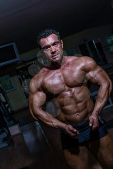 muscular bodybuilder showing his upper body