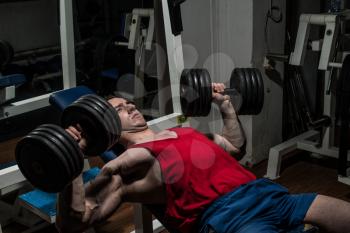 young bodybuilder doing bench press for chest