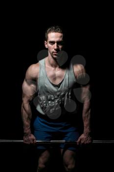 young bodybuilder posing on black background
