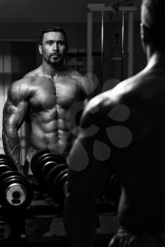 Latin Bodybuilder Working Out Biceps - Dumbbell Concentration Curls
