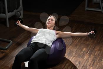 Young Woman Doing Heavy Weight Exercise For Chest