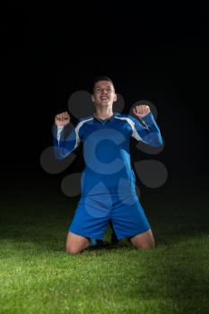 Man Soccer Player Celebrating Victory In Blue Uniform On Black Background