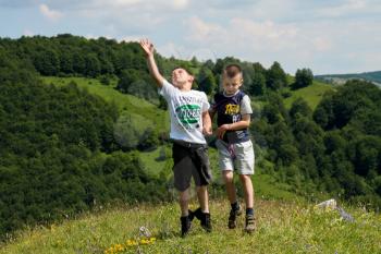 kids jumping in meadow