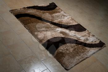 Brown Pattern Carpet Lying On Floor