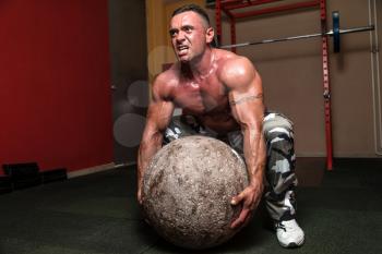 Bodybuilder Trying To Pick Up A Stone