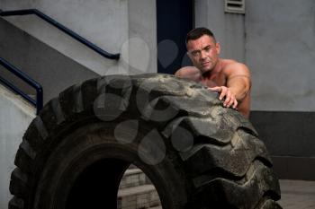 Muscular Man Resting After Tire Flip