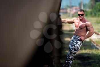 Male Bodybuilder Holding On To Train