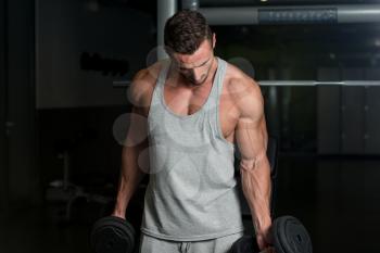 Young Muscular Man Lifting Weights
