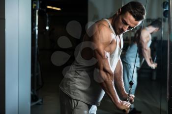 Bodybuilder Doing Heavy Weight Exercise For Triceps With Cable