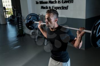 Young Man In Black T-Shirt Doing Barbell Squat