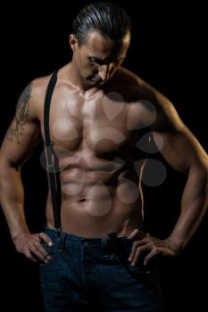 Sexy man with black suspenders over naked chest