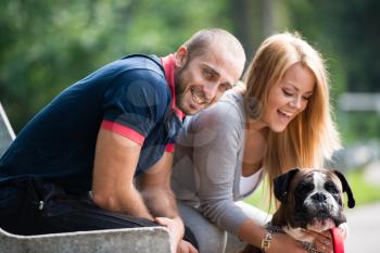 Beautiful Couple With The Dog