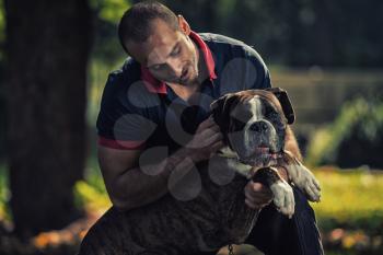 Man Playing With Dog In Park