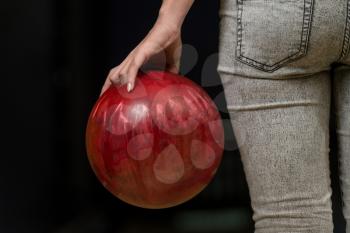 Close-Up Of A Butt Next To A Bowling Ball