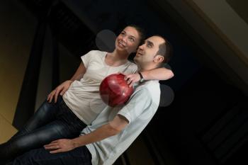 Couple Embracing At The Bowling Alley