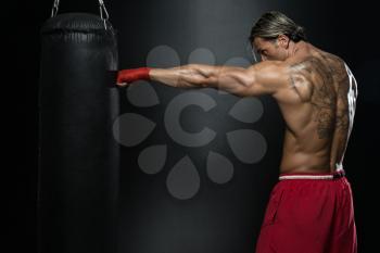 A Man With A Tattoo In Red Boxing Gloves - Boxing On Black Background - The Concept Of A Healthy Lifestyle - The Idea For The Film About Boxing