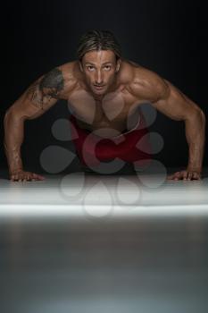 Middle Age Athlete Doing Pushups As Part Of Bodybuilding Training In A Studio