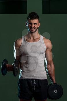 Men In Gym Exercising With Dumbbells