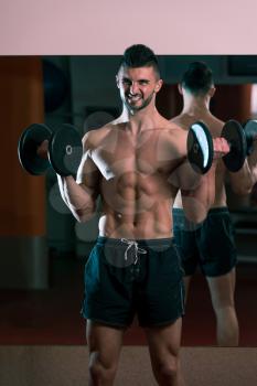 Young Men Doing Exercise For Biceps