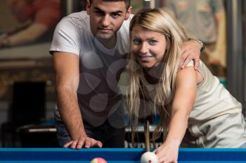 Couple In A Nightclub Playing Pool