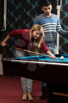 Young Couple Plays Billiards