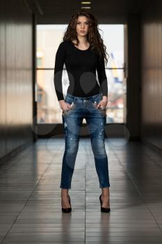Fashion Model Wearing Jeans And Black Long Sleeve